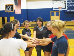 Sarah Sprauer, just right of center, is the new head volleyball coach at Kennedy High School.l
