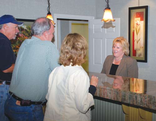 Guests are greeted at the reception desk.