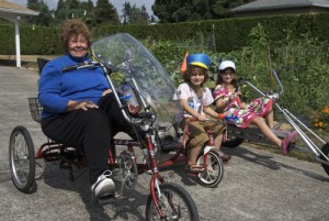 With grandchildren in tow, Connie Lauzon rides her recumbent bicycle through her Mt. Angel neighborhood. From left are Connie, Sebastian, 5, and Avielle, 8.