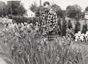 Rholin Cooley, photographed in 1949, tends irises in Silverton. He and his wife, Pauline, started Cooley\'s Gardens. Today his grandson, Rick Ernst, carries on the business