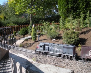 A scale model train loops through miniature trees in the Children\'s Garden at The Oregon Garden.