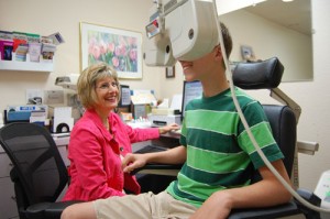 Dr. Terri Vasché, who specializes in vision therapy, tests the eyes of Derek Wiens, 13, of Sheridan.