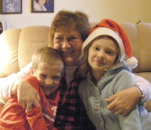 Susan Moser Robinson receives hugs from her grandchildren, Ivan and Tess.