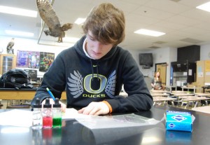 Junior Lane Martin finishes a lab he missed when he was missed school due to an illness.