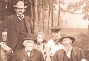Silverton\'s country boy and world-famous cartoonist, Homer Davenport (standing) attends the Lewis & Clark Centennial Exposition in Portland, 1905, with his children and father Timothy Davenport (seated, right). 