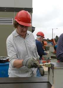 Connie Miller pitches in during the Aug. 13 volunteer work day on the community center.
