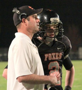 Silverton High School head football coach John Mannion talks with his sophomore quarterback Jonas Dahl during a recent home game.