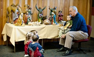 Jerry Lauzon talks about the angel, one of the 29 figurines of the century-old créche at St. Mary Catholic Church.  