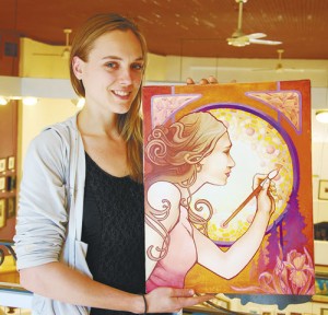 Tonya Smithburg holds her original painting that became the poster image for the 2012 Silverton Fine Arts Festival  
