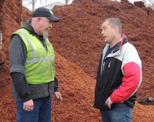 Bill Wolford, right,  engages in  a conversation in the midst of barkdust mountains.