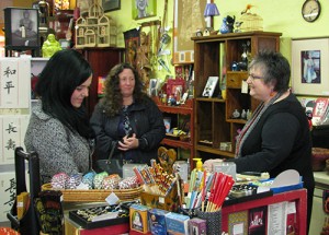 Renee Bianchi (right) helps customers at Stone Buddha.