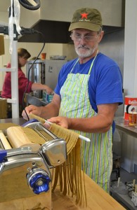 Wayne Huisman operates the pasta cutter.