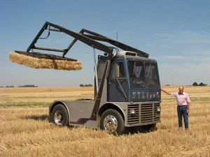 Stan Steffen stands next to a hay loader that he helped to design after his brother’s accident. Photo by Brenna Wiegand