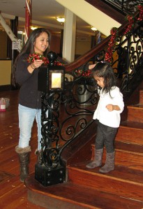 Daisy Salem decorates the Wolf Building while her daughter, Jasmine supervises. 