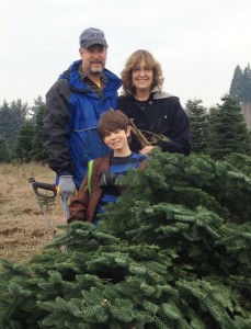 Rob and Andrea Larson and their grandson Micah getting a Christmas tree. 