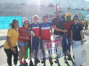 Hilary and John Cornwell (in red, white & blue shirts), Parker Jones (in Uncle Sam hat), and Andrea Koplay (with bandana) pose with Brazilian and Portuguese soccer fans in Manaus, Brazil before the US vs Portugal World Cup game.