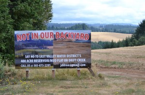 The sign is across the street from Victor Point Elementary School. Behind the sign is where the proposed Drift Creek reservoir would be built.