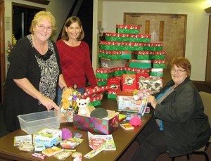 Marilyn Schmidgall, Julie Birch and Sally Newkirk wrap preasents for Operation Christmas Child.