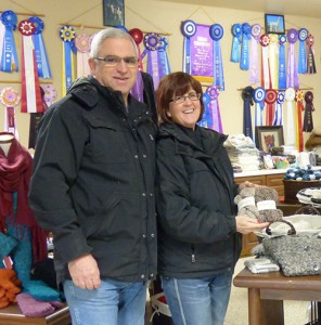 Bill and Jennifer Cameron with some of the ribbons their alpacas have won.