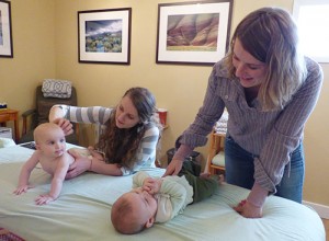 Katie Rablin giving neice Etta a needle-less acupuncture treatment with sister Beverly and Katie’s son Ancil Fisher nearby.