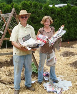 Brenna Wiegand and her father, Don Conway, prepare mulch for her garden.