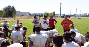 Fox coach John Mannion addresses his squad at the end of morning drills Aug. 17. Silverton opens the season Friday at Wilson of Portland. James Day for Our Town