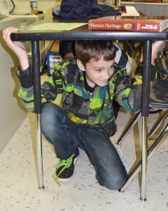 Scotts Mills Elementary  students got under their desks and held on for the duration of an imaginary earthquake during the Great Shake-Out Drill Oct. 15.