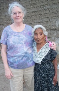 Judy Gabriel, left, with 90-year-old midwife Lena, who is wearing the new dress Judy brought her.