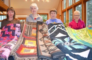 Stitches in Bloom Quilt Show participants Kathy Bovee, Mary Goodson,  Carol Wallace, and Carol Heist  with their creations.