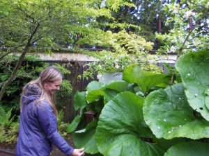 Heather Desmarteau-Fast inspecting plants in the garden.