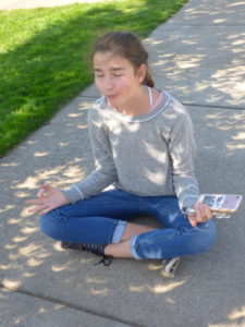 15 year old Giselle Linn sitting in among the eclipse crescents at Silverton High School (2)