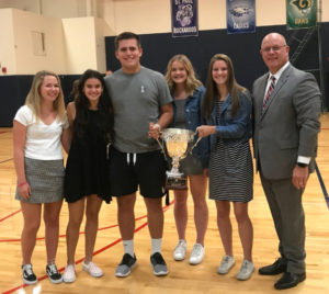 Claire Seiler, left, Clarissa Traeger, Nick Suing, Hallie Sprauer, Kalyssa Kleinschmit and new Kennedy Principal Dale Pedersen take possession of the school’s third consecutive Oregonian Cup.  