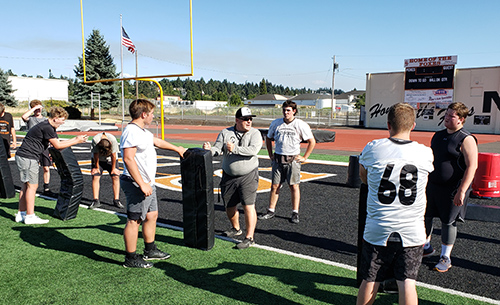 Foxes second-year coach Dan Lever works with his linemen on footwork at a practice Aug. 7. Silverton opens at home on Sept. 1 vs. Dallas.  James Day