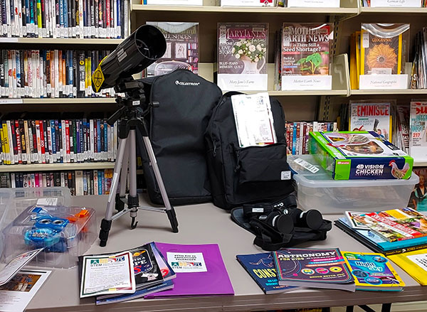 A STEAM display features a telescope and books on astronomy at Mount Angel Public Library during winter of 2023. Submitted Photo