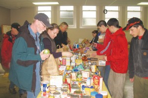Volunteers sort and store packaged foods donated in SACA\'s annual Fall Food Drive.