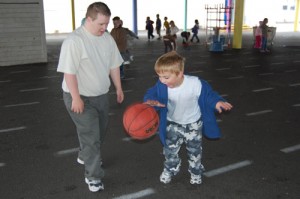 Sean Grady plays basketball with Jonathan Shackelford.