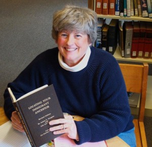 Roxanne Walstrom sits at Silver Falls Library surrounded by genealogy books. Walstrom is program chair of the genealogy club, Ancestry Detectives, which meets monthly at the library. 