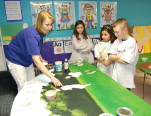 Third graders at Eugene Field Elementary learn muralist techniques from Lori Webb.     