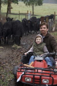 Jonathan Ehmig and 5-year-old son, Ethan, bring in some young black Angus cattle on Ehmig\'s 160-acre Highland Oak Farm in Scio.