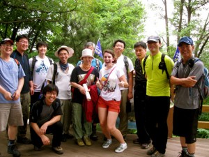 Madeline Lau, center, in red shorts; joins a group hiking in the mountains of South Korea.