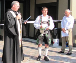 Father Philip Waibel blesses the new Festhalle with Oktoberfest Board President John Gooley and Mount Angel Community Foundation Fundraising Committee Chairman Dave Kohler beside him. 