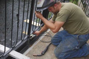 The artistry is by Jesse Cox, who lets sparks fly as he welds the fence into place. 