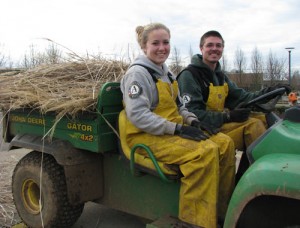 AmeriCorps team members Shelby Schoepf, left, of Houston, Texas, and Ben Erickson of Gardner, Mass., haul away cuttings of pampas grass. They are the first of two back-to-back teams providing labor toward improvements at The Oregon Garden. 