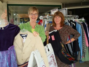 Josie Christensen, left, and Pam Altree, co-owners of The Clothes Garden, say budget-conscious shoppers are coming into recycle stores to find treasures at lower cost.