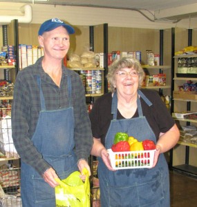 Long-time SACA volunteers Ted and Anne Henderson work to stock the food bank pantry.
