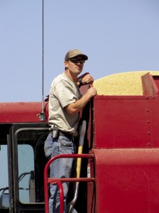 Ryan Eder helps out at a neighbor’s wheat farm during harvest. Reduced production in Russia and Canada have made U.S. prices climb.
