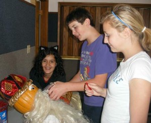Pratum students decorate their scarecrow king scarecrow.