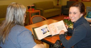 Kaylee Aman visits with a resident at Providence Benedictine Nursing Center. 