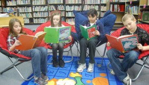 Robert Frost fourth-grade students Ella George, Justice McBride, Amy Carbajal and Zach Gearhards read Dr. Seuss books.