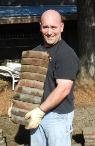 Karl Bischoff carries paving stones to storage